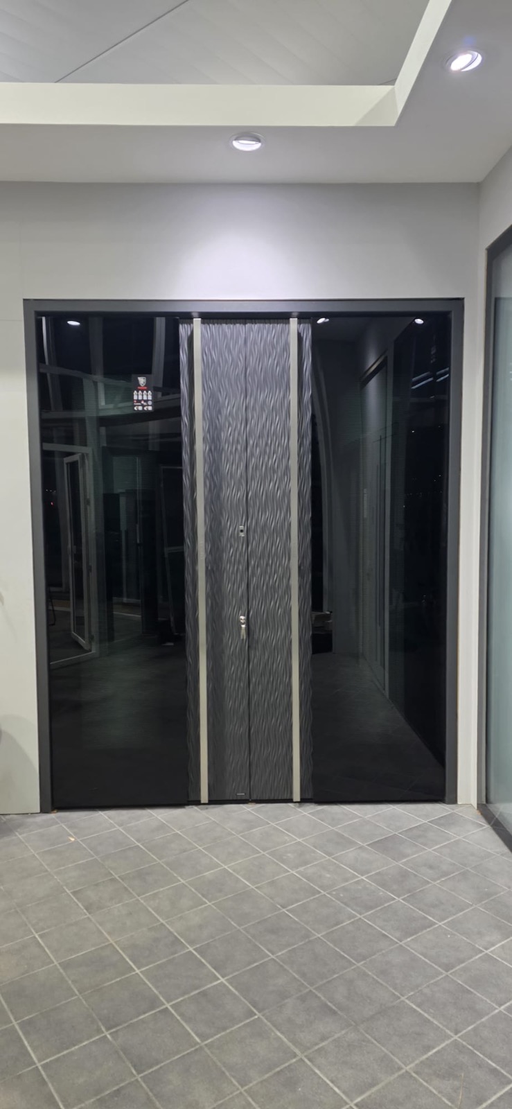 Modern dark commercial double-door entry on tile floor