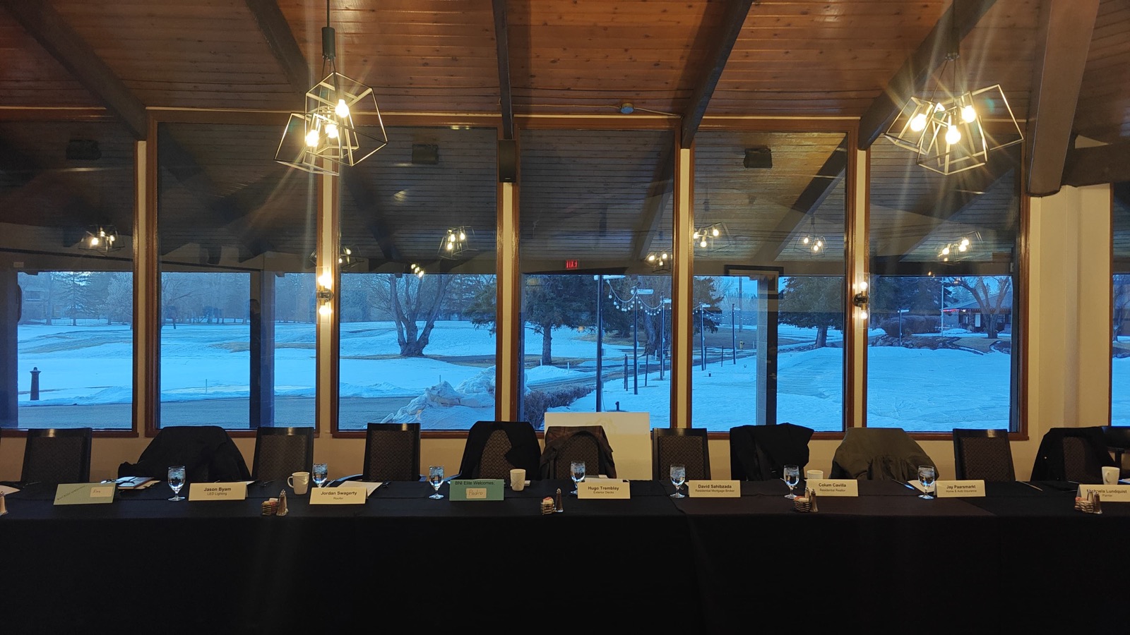 Banquet hall interior with floor-to-ceiling windows overlooking snowy grounds