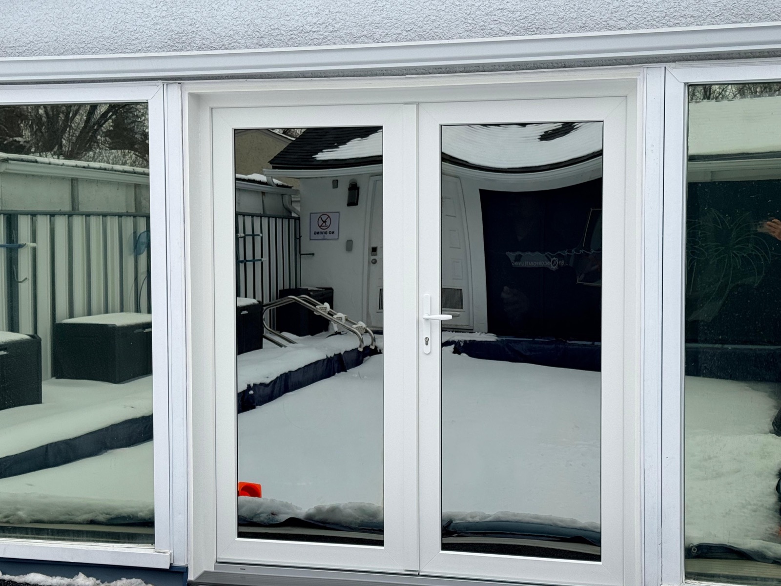 White uPVC French double door with sidelights at pool and spa enclosure entry