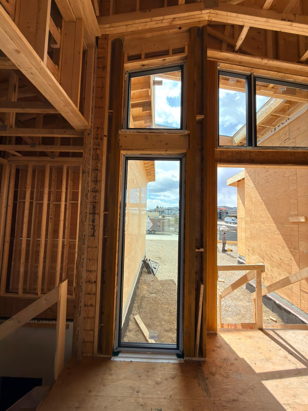 Tall black-frame patio door from interior framing
