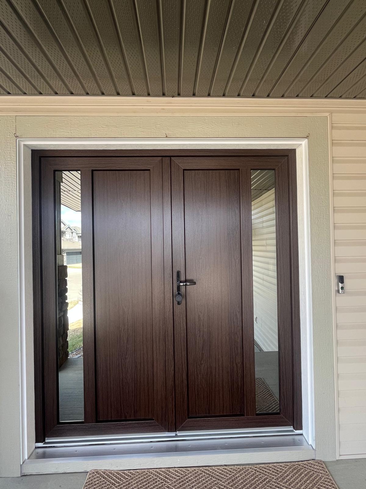 Walnut entry door second angle — porch with doormat and stone accent