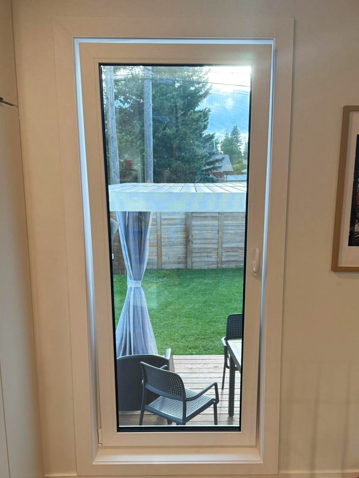 White tilt-turn kitchen door to the backyard deck