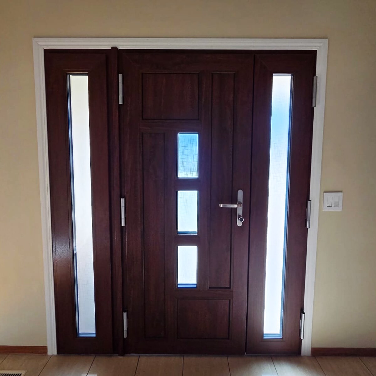 Dark walnut entry door with frosted glass and sidelites, interior view